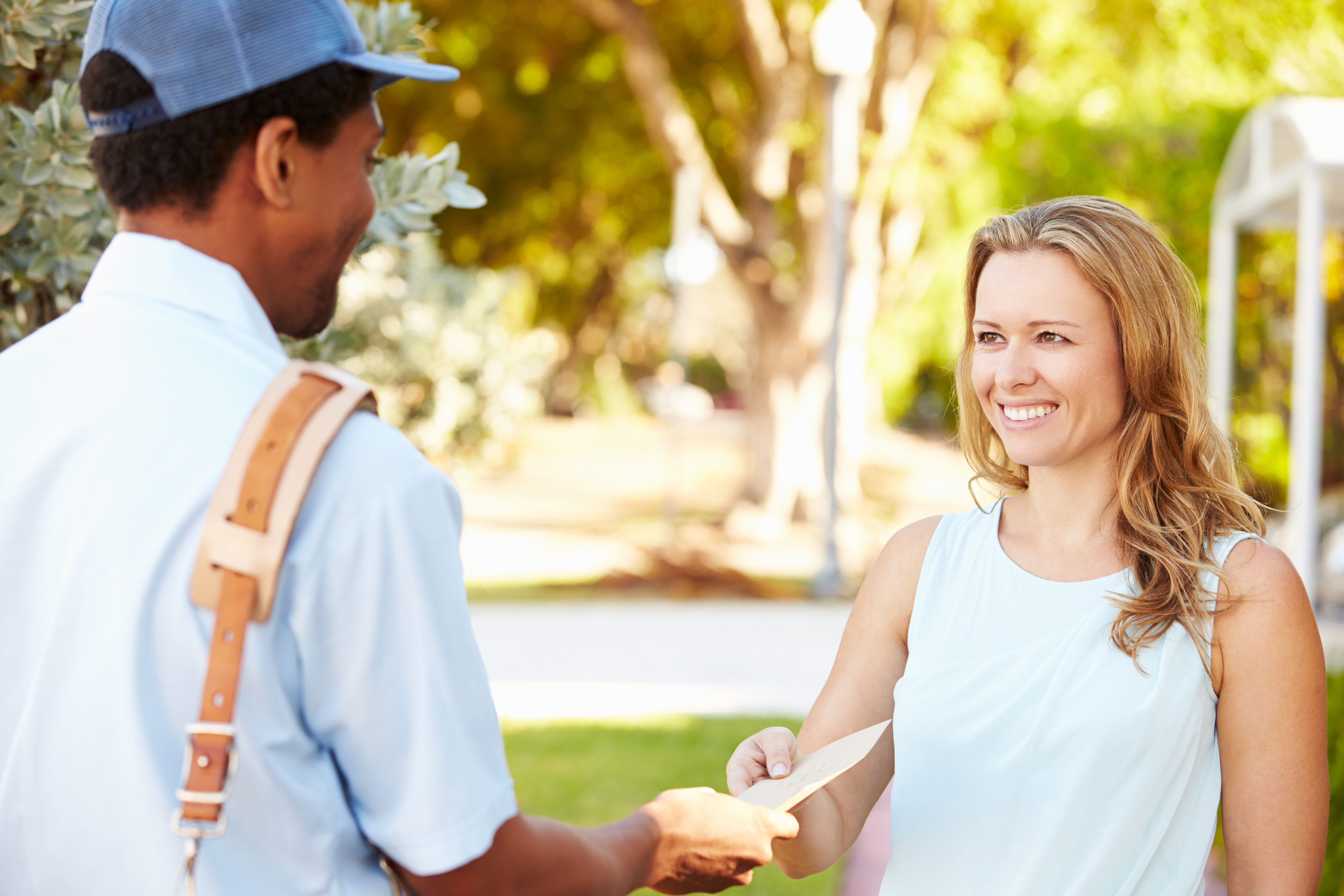 Mailman Delivering Mail to Smiling Woman - Mailing Methods